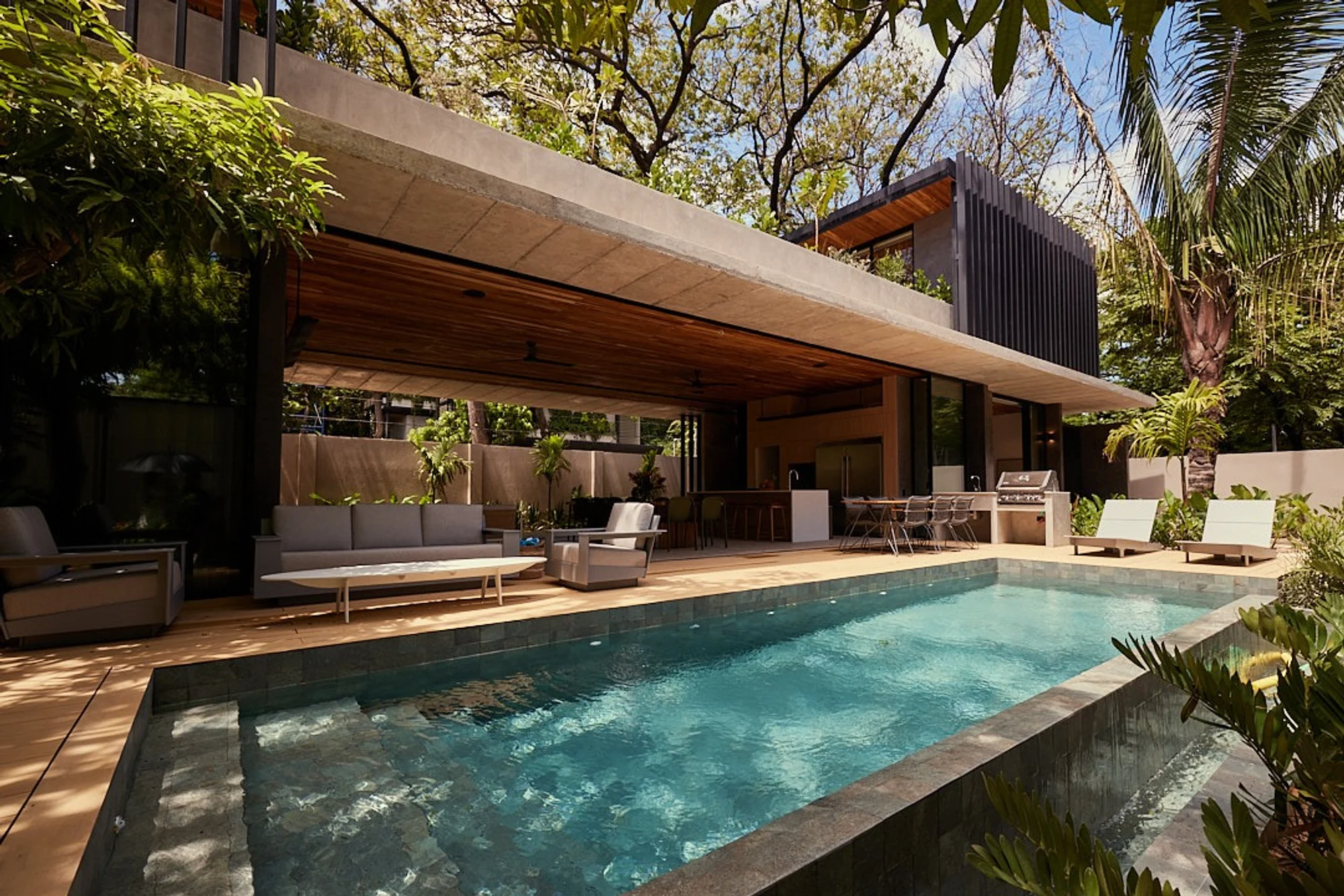Calma House villa heated pool with cabana ceiling and palm trees, North Guiones Nosara, Costa Rica