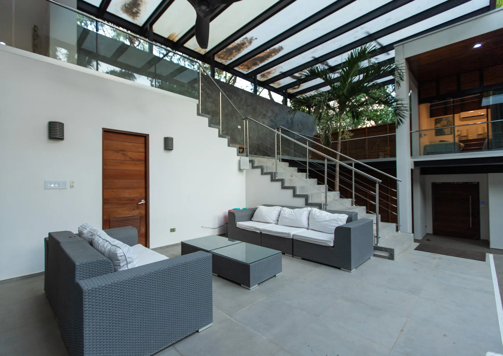 Casa Almendra villa living area with central staircase and grey seating, K Section Nosara