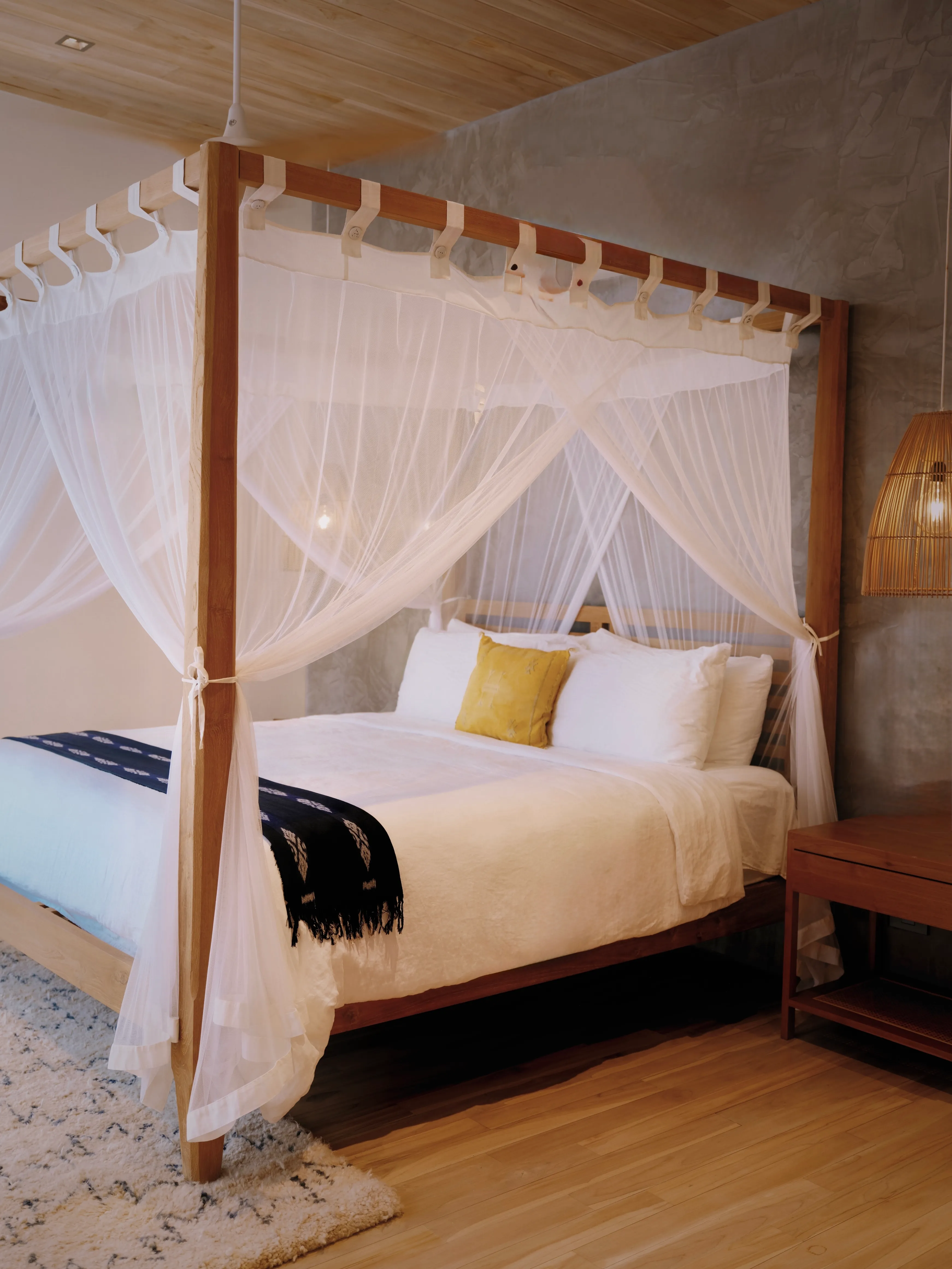 Tres Hermanas villa king bedroom with white canopy drapes and ornate frame, Playa Guiones Nosara