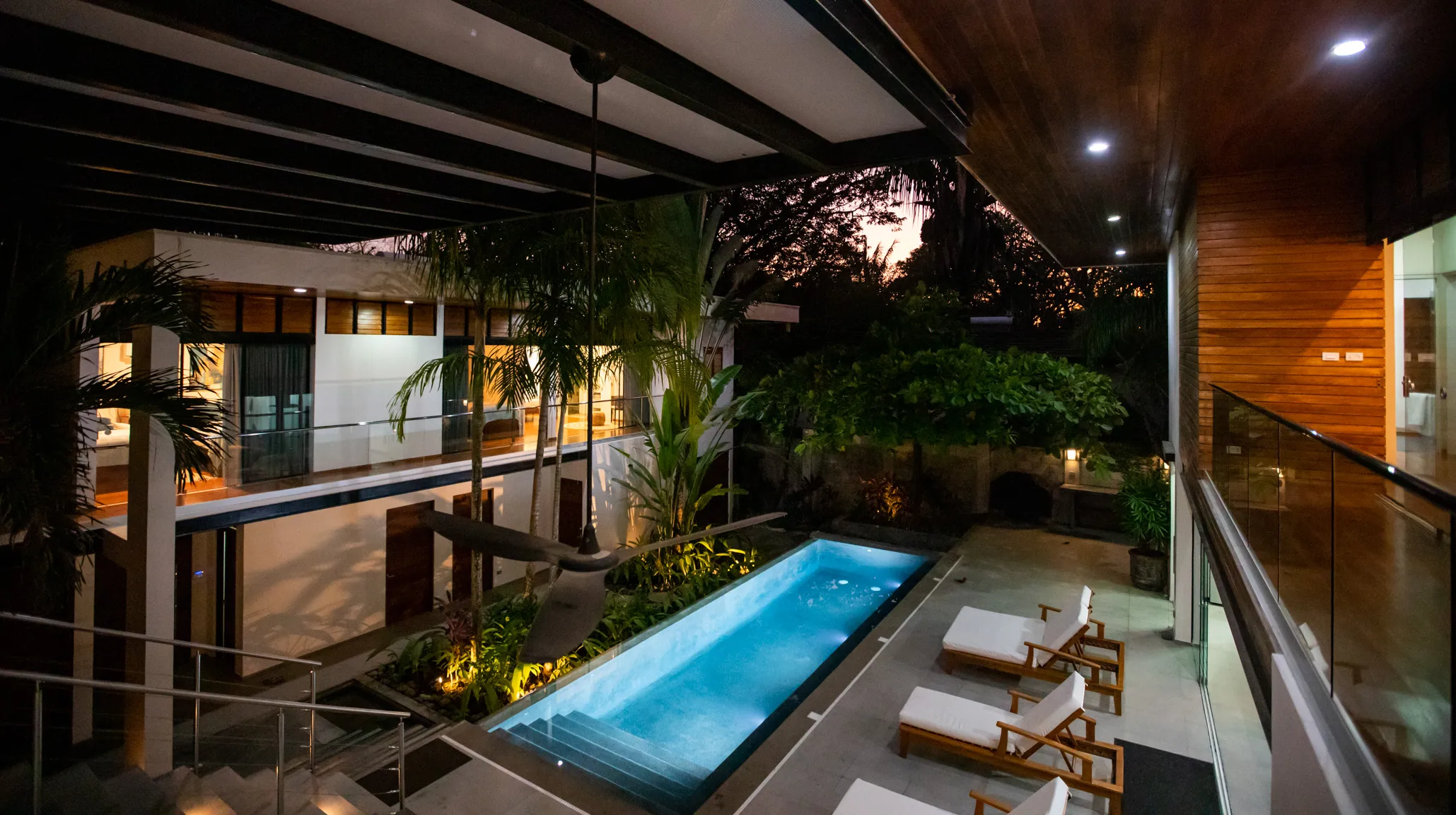 Casa Almendra villa pool with deck and sun loungers at night, Playa Guiones Nosara