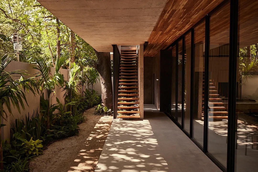 Calma House villa outdoor walkway with bamboo privacy screens, Nosara