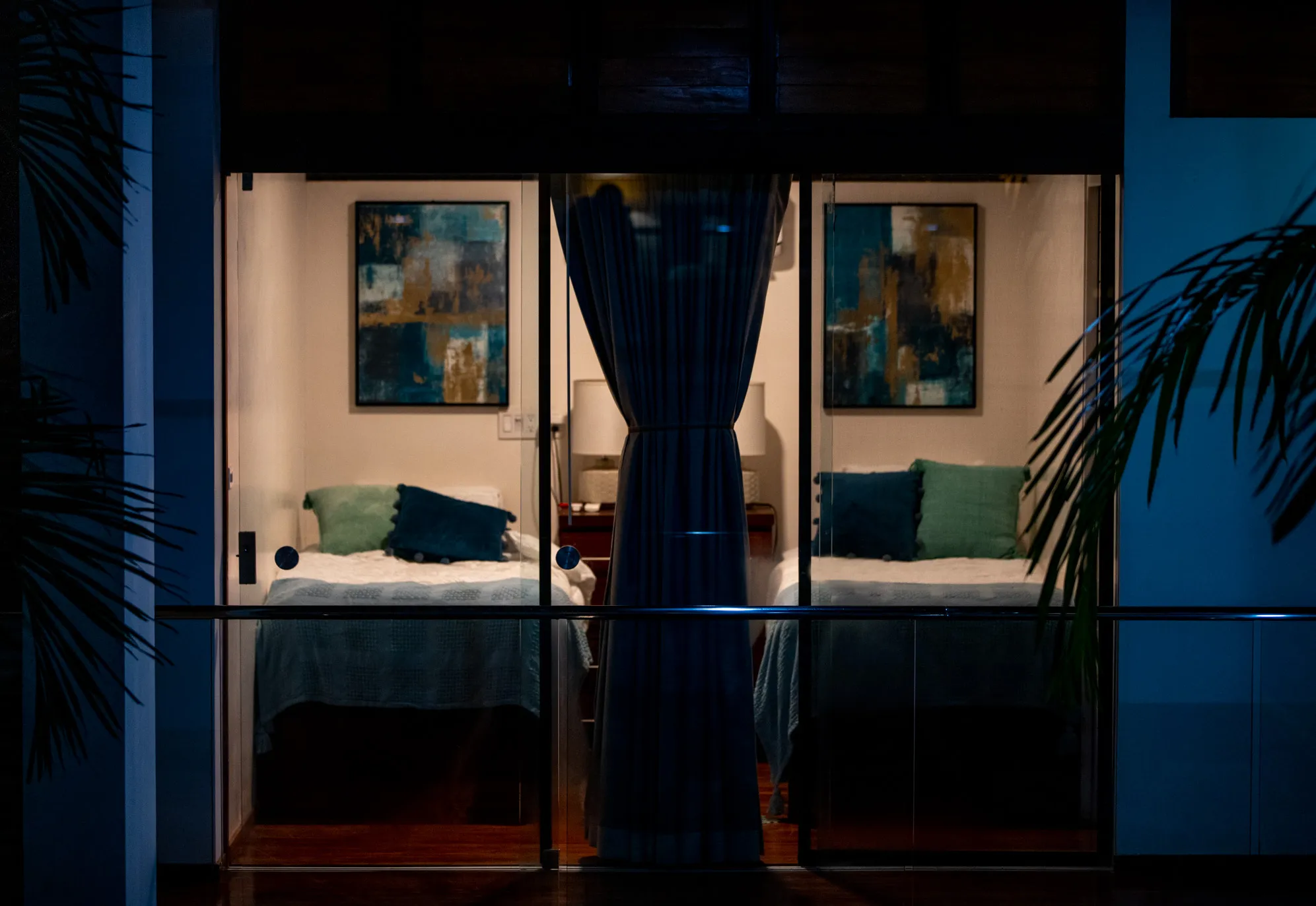 Casa Almendra villa bedroom viewed through dark curtains, atmospheric evening light, Nosara