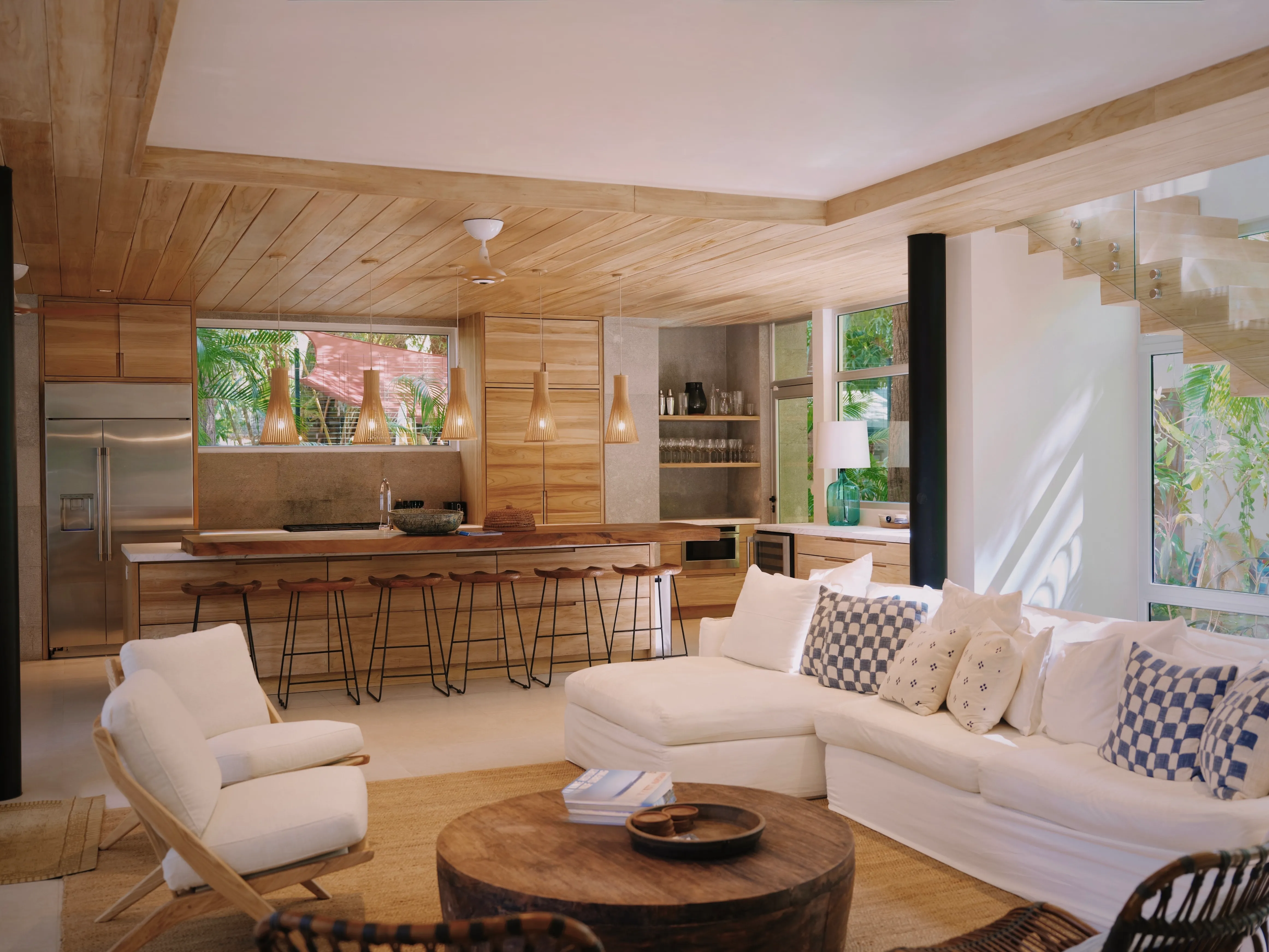 Tres Hermanas villa open kitchen and living area with bar stools, Nosara