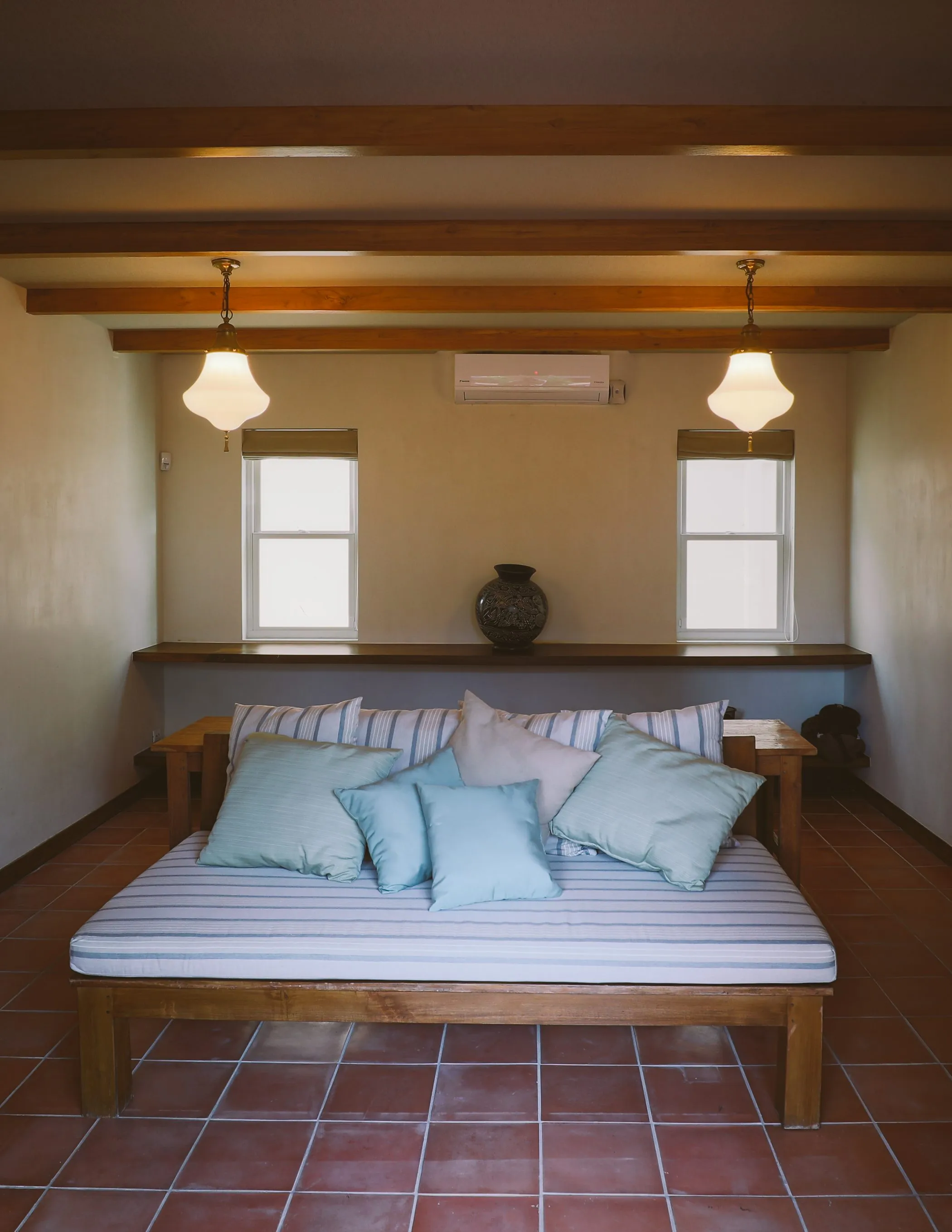 Casa Oceanus villa bedroom with king bed alcove and blue accent pillows, Nosara
