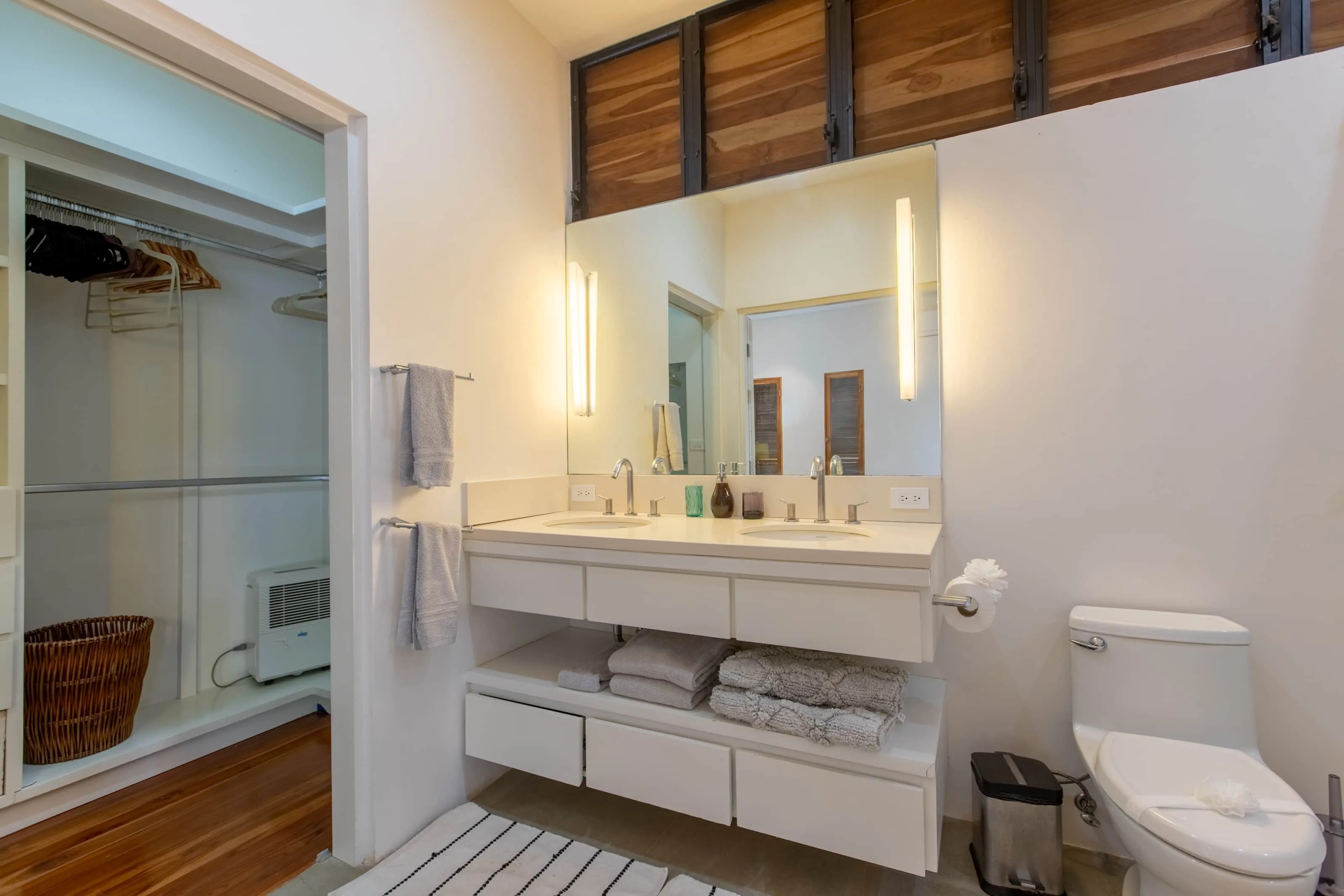 Casa Almendra villa bathroom with double vanity and natural wood accents, Nosara