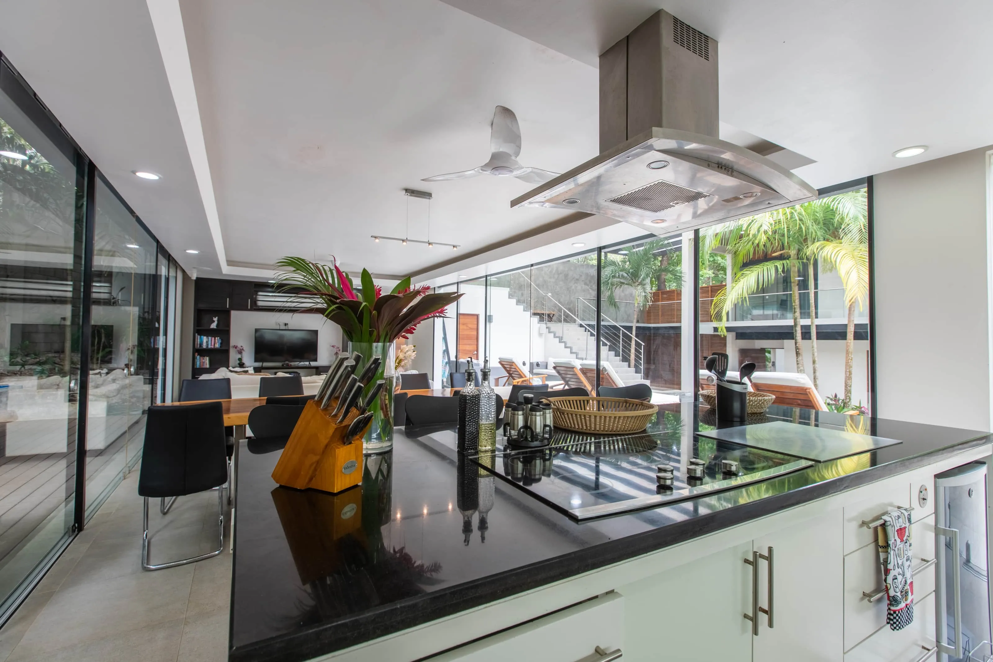 Casa Almendra villa kitchen counter angled toward the outdoor pool area, Playa Guiones Nosara, Costa Rica