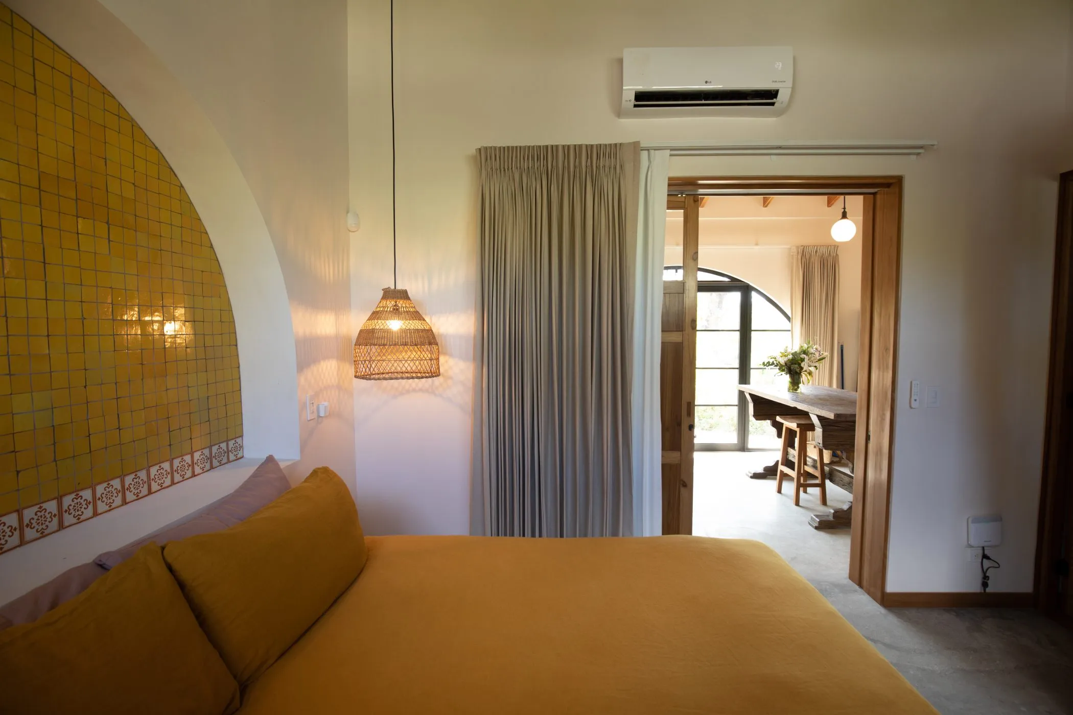 Casa Oceanus villa bedroom with yellow accent wall and pendant lighting, Nosara, Costa Rica