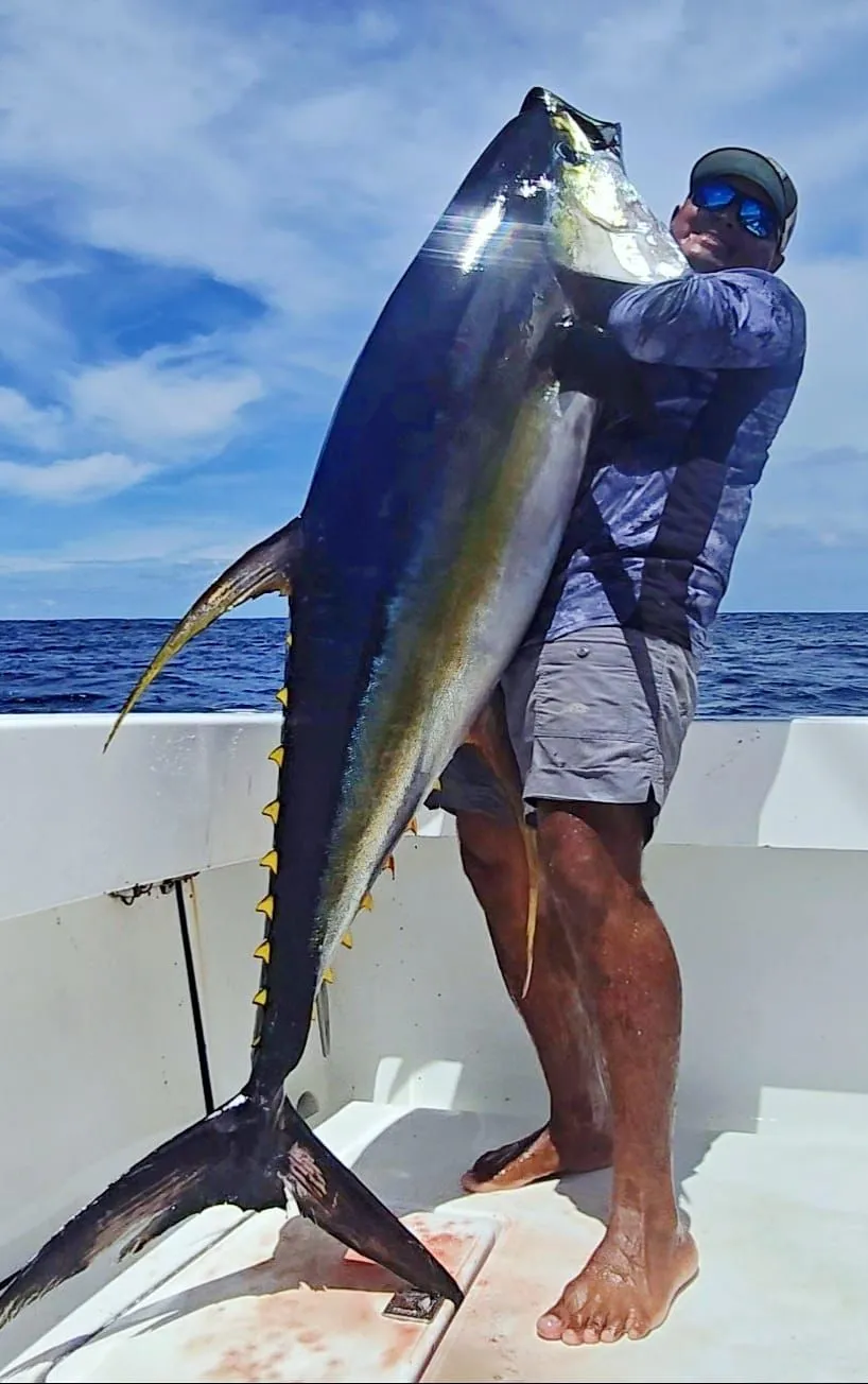 Captain Alex Moreno holding a large yellowfin tuna aboard the boat off Nosara, Costa Rica