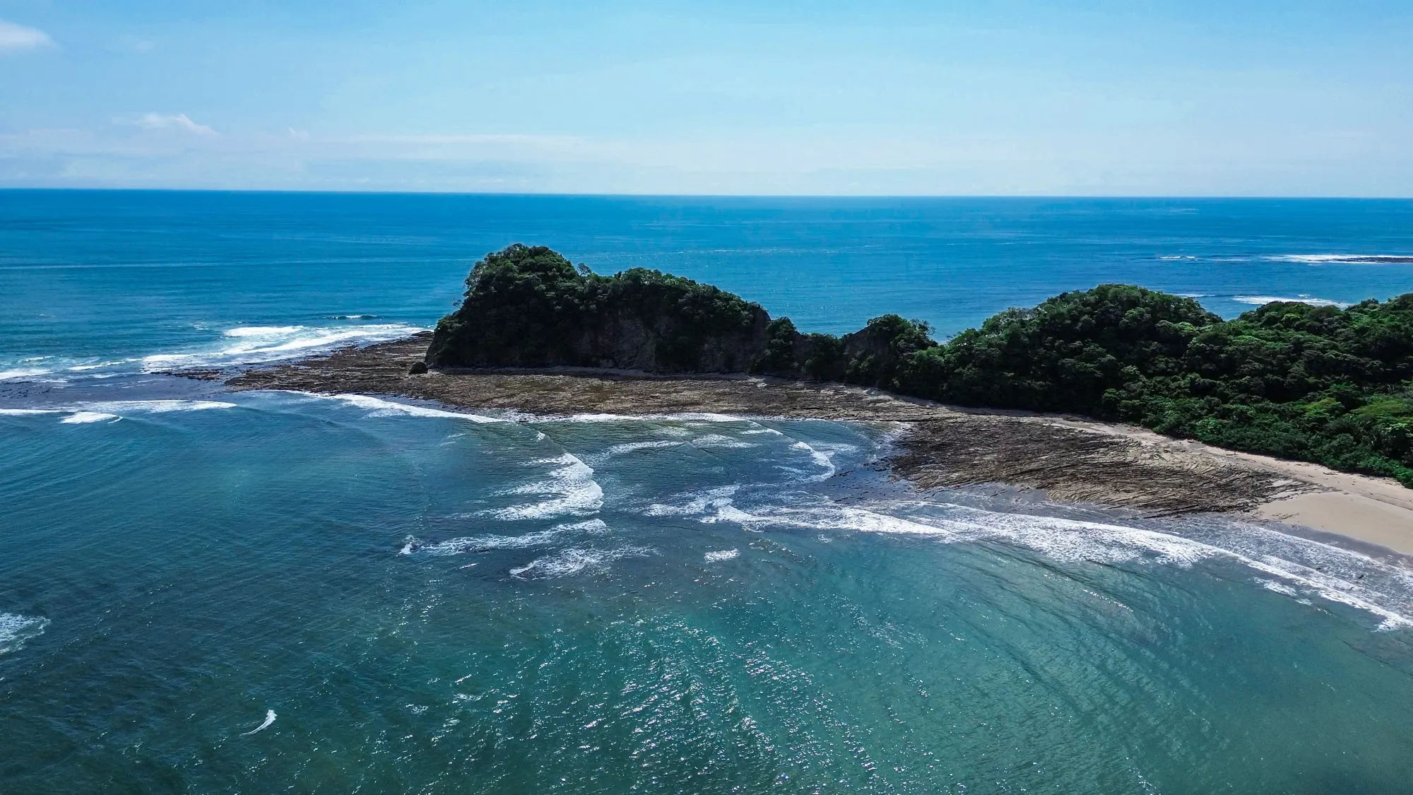 Aerial view of the Nicoya coastline near Nosara with reef and turquoise Pacific water, Costa Rica