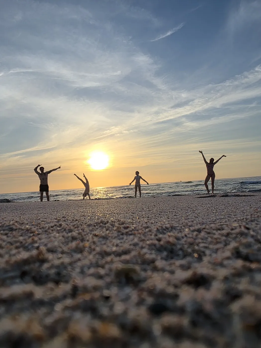 Four silhouettes playing on the sand at sunset in Nosara