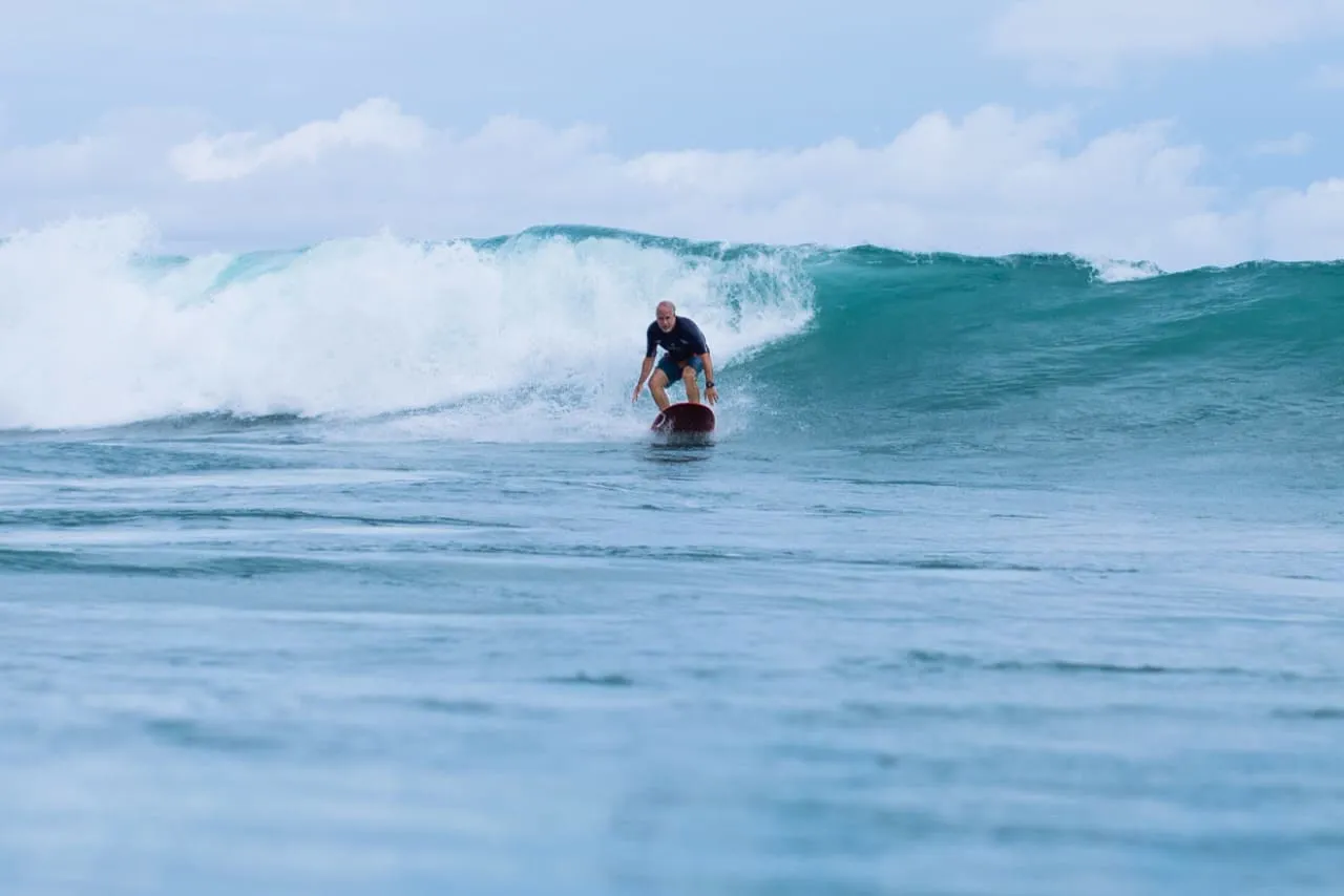 Surfer riding a clean Playa Guiones wave, Nosara, Costa Rica